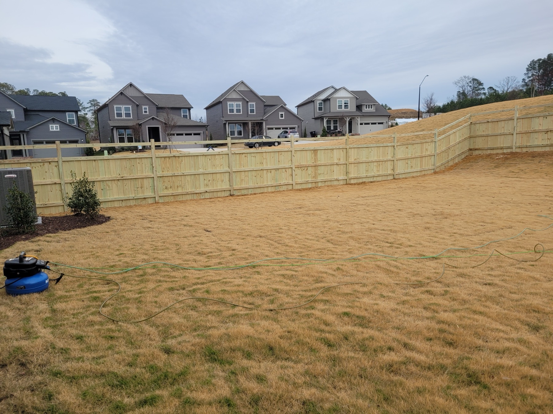 New wood privacy fence line between two homes.